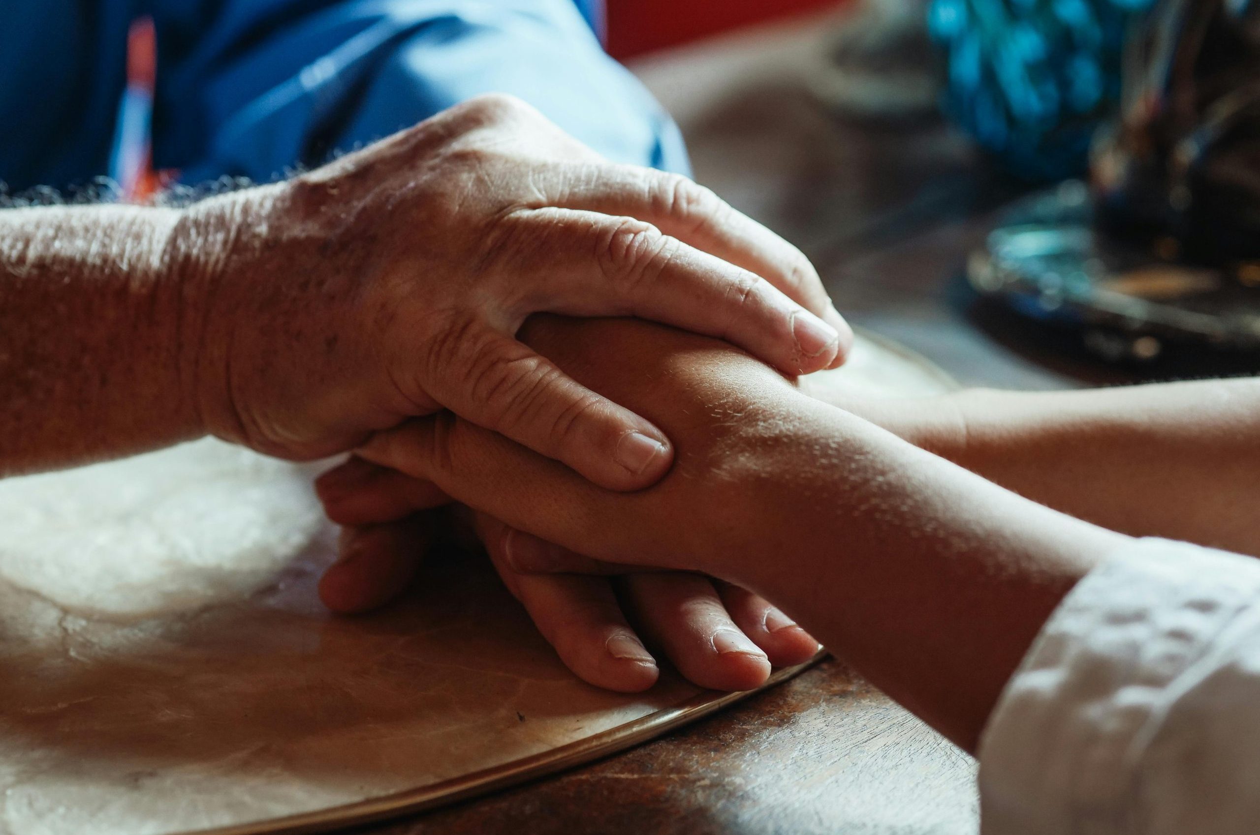 Close-up of supportive hands showing love and care. Ideal for themes of empathy and bonding.